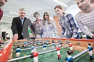 Employees playing table soccer