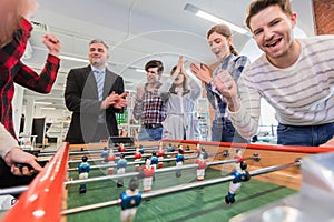 Employees playing table soccer