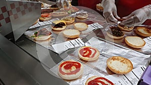 Employees Preparing Burgers At The Burger Restaurant Five Guys