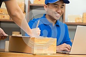 Employees receive parcels from customers and writing addresses for shipping products,