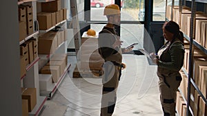 Employees review warehouse inventory