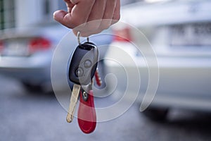 Employees sale send car keys to tourists after making a lease. Rent or buy car concept