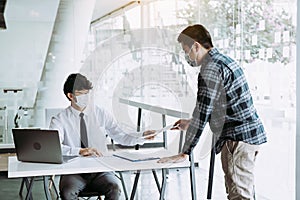 Employees submit documents at their office while wearing masks during the outbreak of the virus