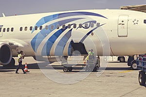 Employees unloading luggage at airport