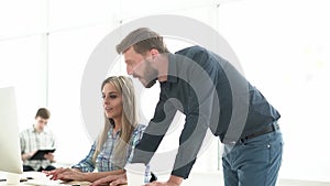 employees using a computer in a creative office.