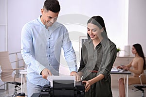 Employees using new modern printer in office