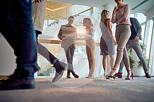 Employees are walking through the company building hallway. Business, people, company