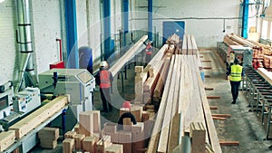 Employees of a woodworking factory are relocating balks