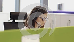 Employees working in call centre office with headsets