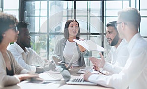 Employees working at computer together, discussing content