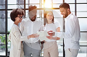 Employees working at computer together, discussing content