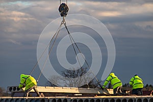 Employees working on the construction of a block of flats. Construction works on house construction