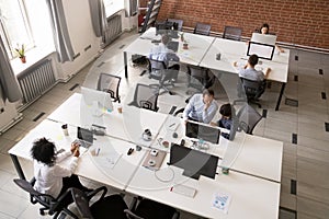 Employees working together in modern open office space