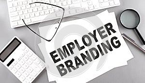 EMPLOYER BRANDING text on paper with keyboard, calculator on grey background