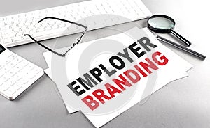 EMPLOYER BRANDING text on a paper with keyboard, calculator on grey background