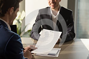 Employer conducting job interview, reviewing good resume of succ