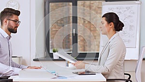 Employer having interview with employee at office