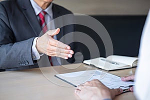 Employer or recruiter holding reading a resume during about colloquy his profile of candidate, employer in suit is conducting a