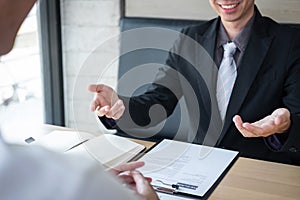 Employer or recruiter holding reading a resume during about colloquy his profile of candidate, employer in suit is conducting a