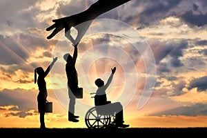 Employer`s hand chooses a healthy worker from a crowd of people and not an invalid in a wheelchair