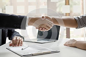 Employer shake hand with job applicants congratulates and welcomes new hires after successful negotiations for a job interview.