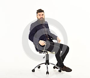 Employer sits in luxury chair and wear smart suit.