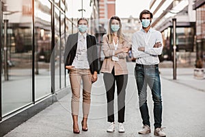 Employers standing outdoor wearing face mask