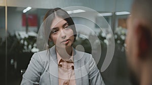 Employment concept. Young lady jobseeker wearing formal wear talking to entrepreneur, sitting at interview at office