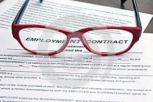 Employment contract. Shot of blank and red glasses