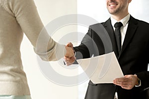 Employment handshake closeup, employer shaking new hire hand, of