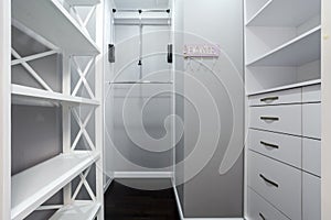 Emplty closet for storing of clothes in brdroom. Shelves and two level clothes rods are built in