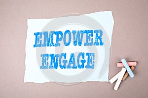 EMPOWER ENGAGE concept. Text on note sheet