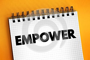 Empower - to give power or authority to, authorize, especially by legal or official means, text concept on notepad