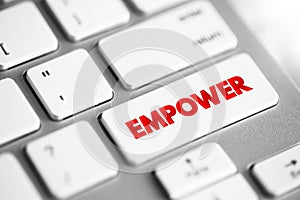 Empower - to give power or authority to, authorize, especially by legal or official means, text concept button on keyboard