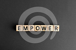 empower - word from wooden blocks with letters