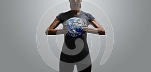 Empowered fit woman holding world in her hands photo
