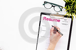 Empoyment concept with resume on white work desk background with pen, glasses top view space for text