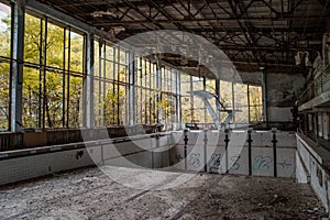 Empty abandoned swimming pool in the abandoned school building located in the Chernobyl ghost town