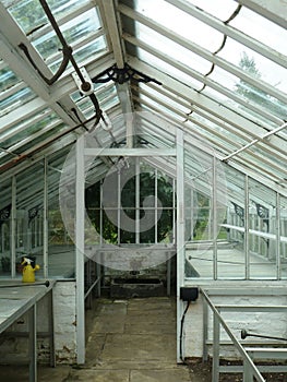 Empty abandoned vintage glass greenhouse