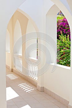 Empty abstract light interior corridor background with arches and sunlight