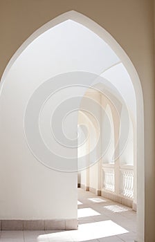 Empty abstract light interior corridor background with arches and sunlight