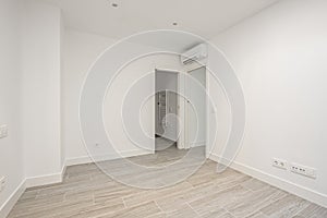 Empty air-conditioned bedroom with porcelain stoneware floors photo
