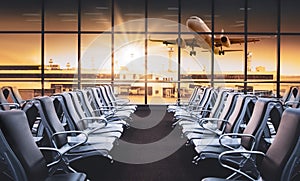 Empty airport terminal lounge with airplane on background. Modern airport waiting area with flyinf airplane and seats. Lounge and