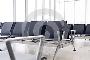 Empty airport terminal waiting area with chairs. Close up photo