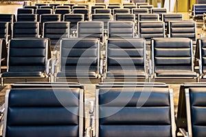 Empty airport terminal waiting area with chairs at night, travel concept
