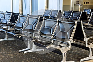 Empty airport terminal waiting area with seats in the departure lounge