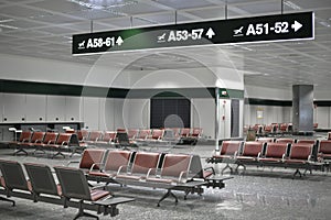 Empty airport waiting room with indications to gates photo