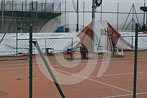 Empty all weather tennis court with umpires chair