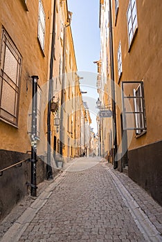 Empty alley amidst residential buildings in old town at capital city against sky