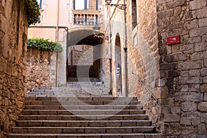 Empty alley with stone stairs in the old town, Girona